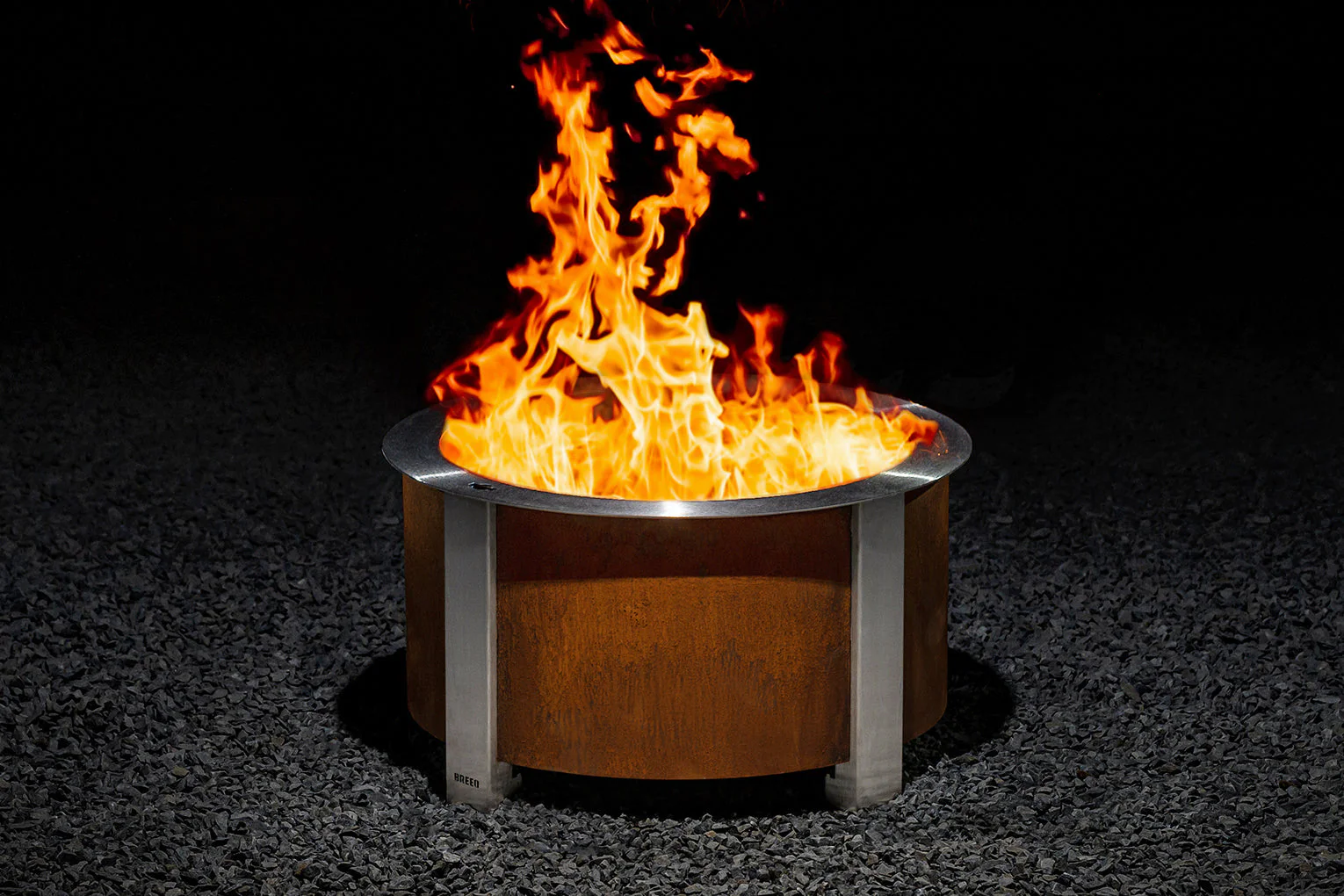 Picture of a Breeo Fire Pit being used. The flame is bright orange.
