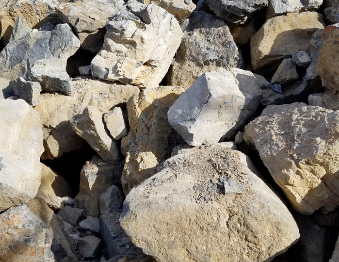Large limestone boulders in a pile.